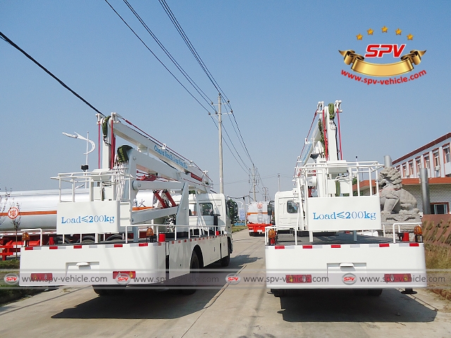 Rearview of 2 units of aerial platfrom trucks are waxed, ready for shipment